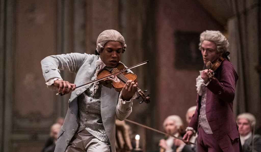 Kelvin Harrison Jr. playing violin as Chevalier