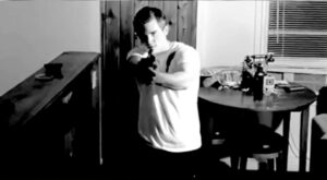 man-holding-gun-pointing-at-viewer